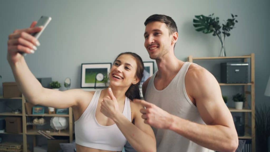 Couple smiling and taking selfie while avoiding competitive energy