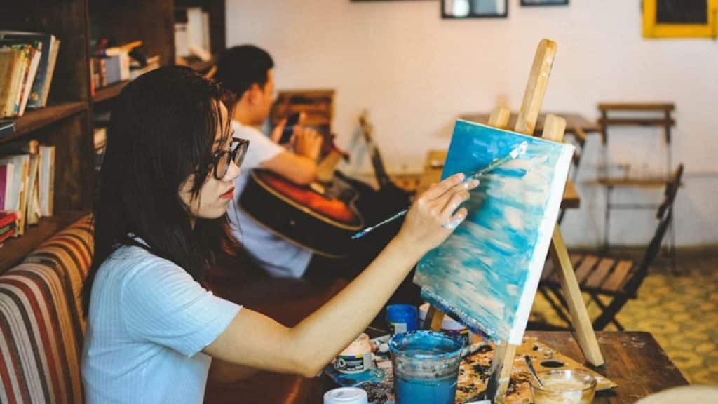 Couple both working on separate hobbies side by side