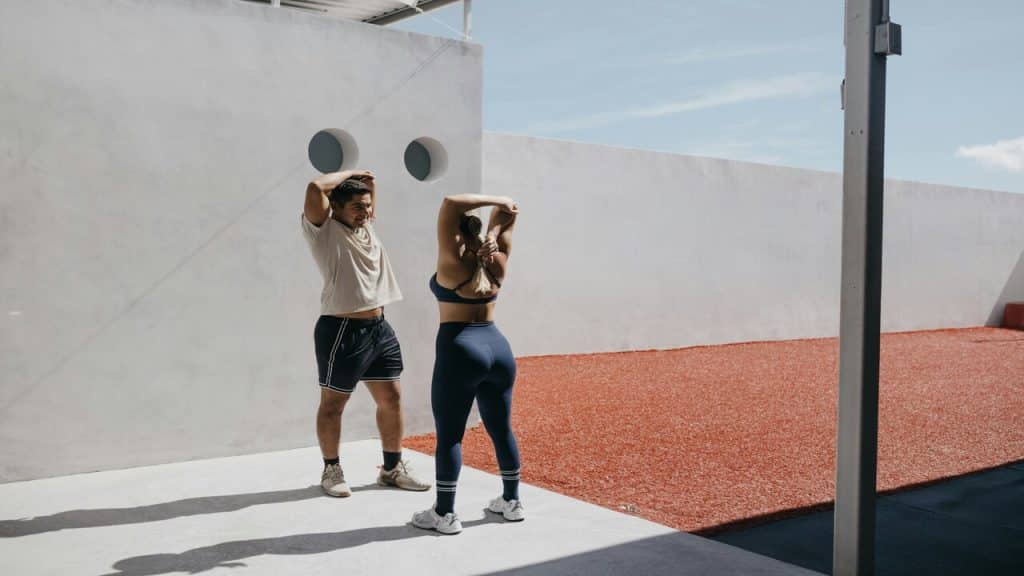 A couple stretching together.