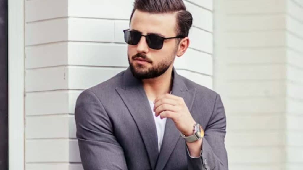 Stylish man adjusting jacket before heading out
