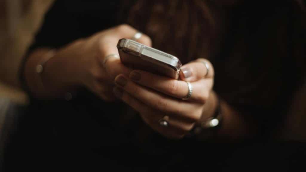 A person holding a smartphone with both hands.