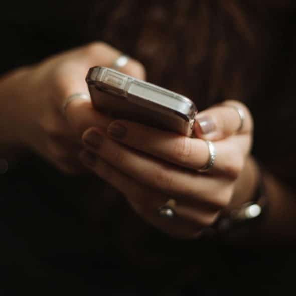 A person holding a smartphone with both hands.