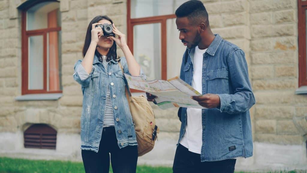 A couple looking at a man.