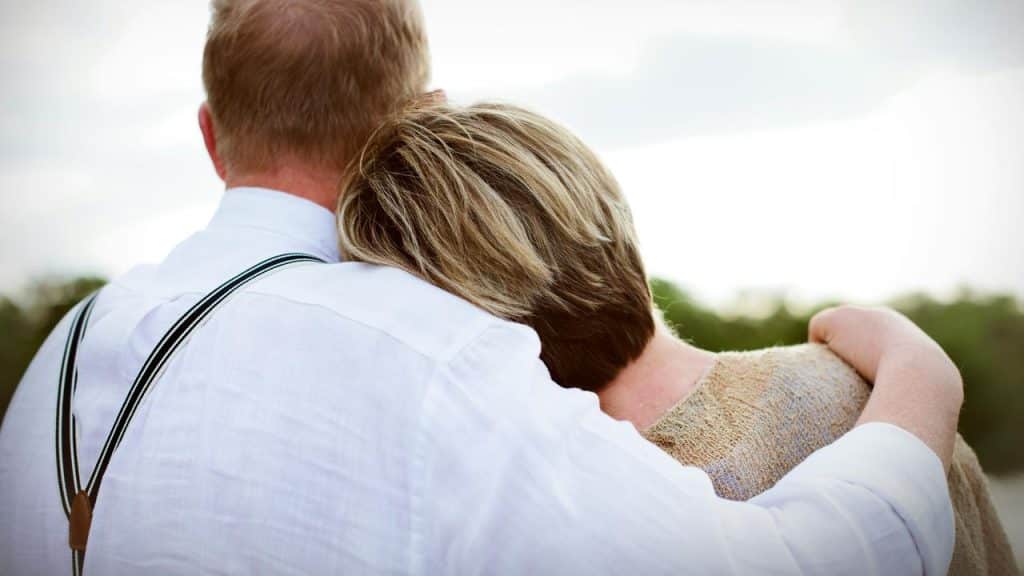 A couple embracing while looking at the view.