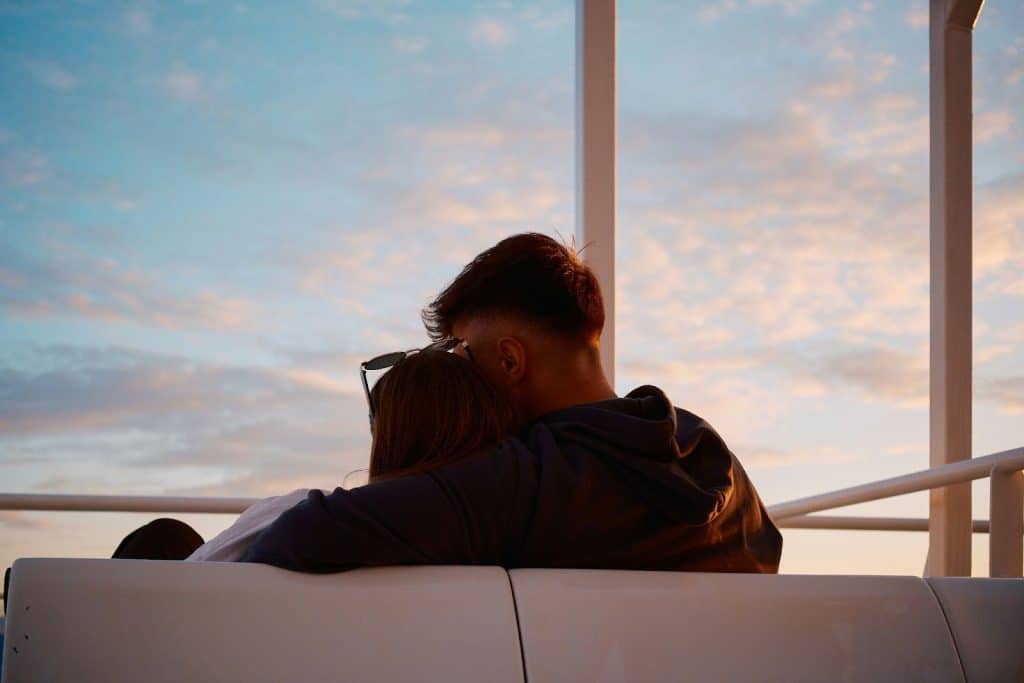 A man and woman watching a sunset