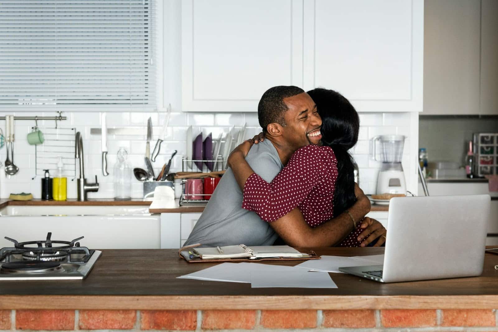 A man and woman hugging as a celebration.