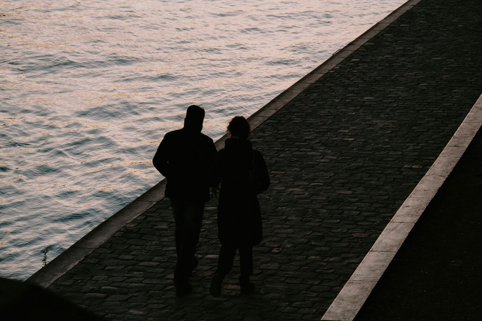 A man and woman having an evening walks.