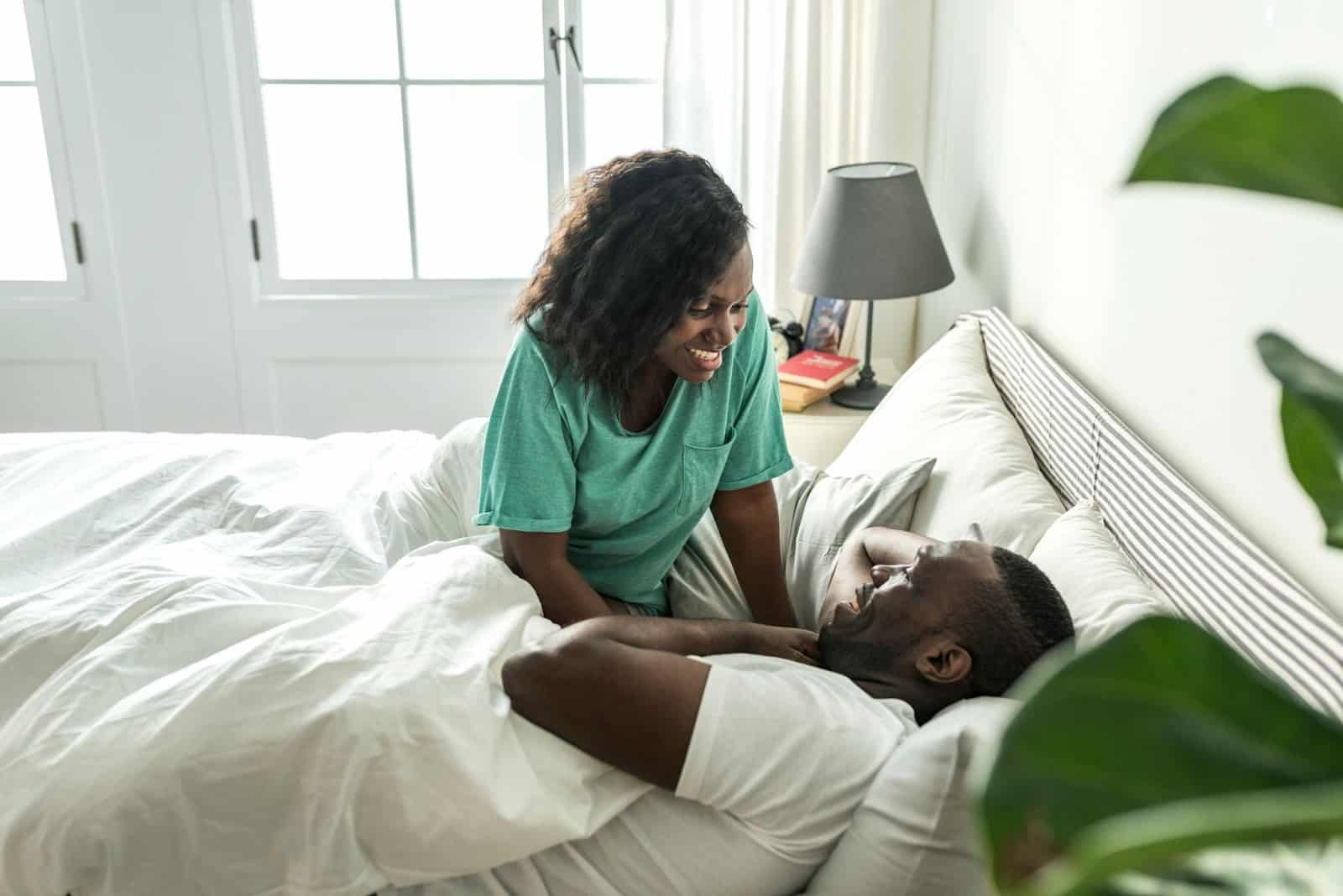 A man and woman at the bed.
