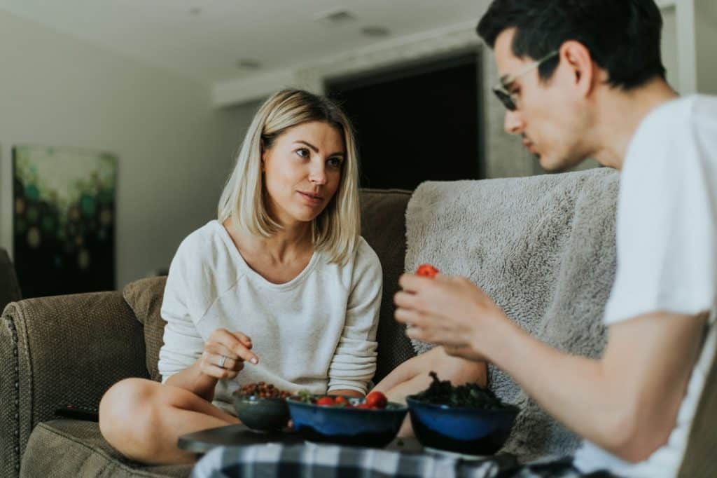 A man and woman eating a healthy foods