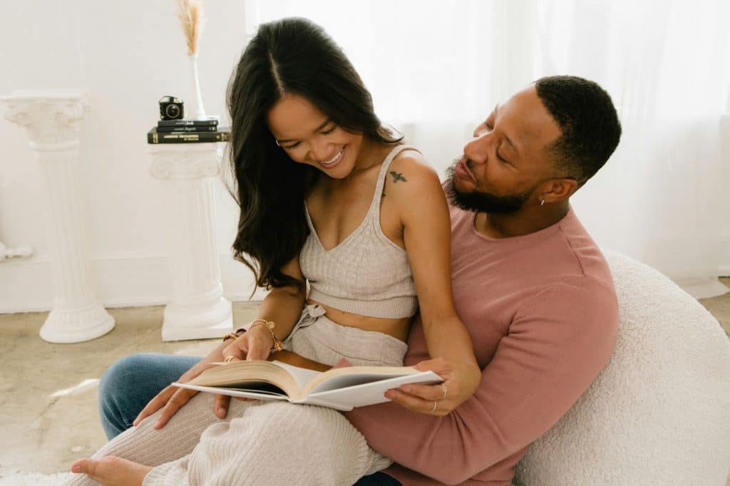 A man and woman reading a book together