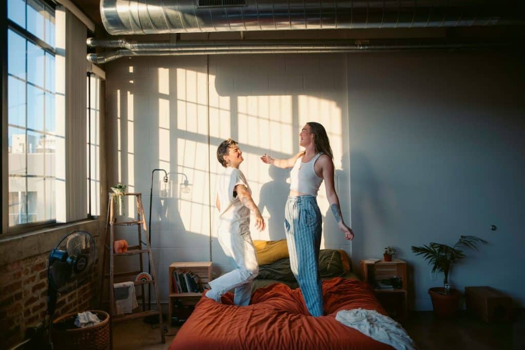 A man and woman dancing at the bed 