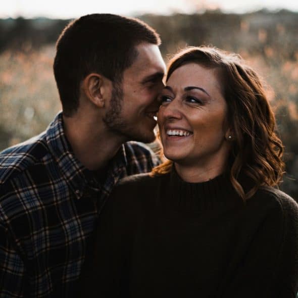 A man kissing a woman’s cheek