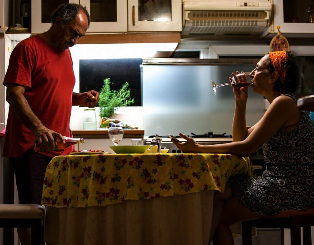 A man pouring a drink to a glass