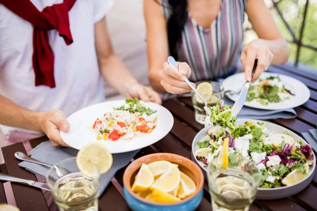 A man and woman eating a healthy foods