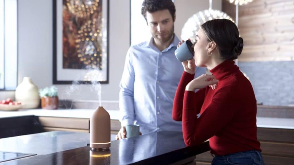 Man nervously explaining while woman looks uninterested