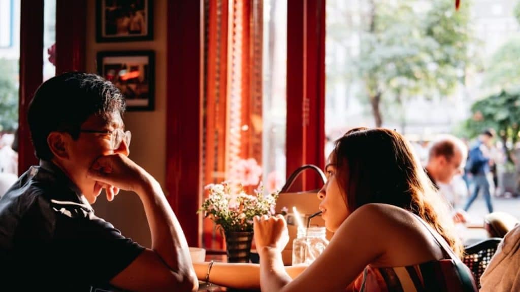 Man suppressing opinions at dinner with a partner