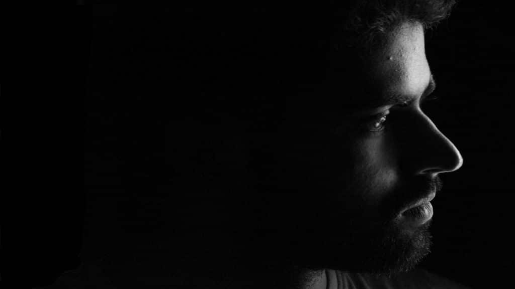 A black and white photo of a sad man