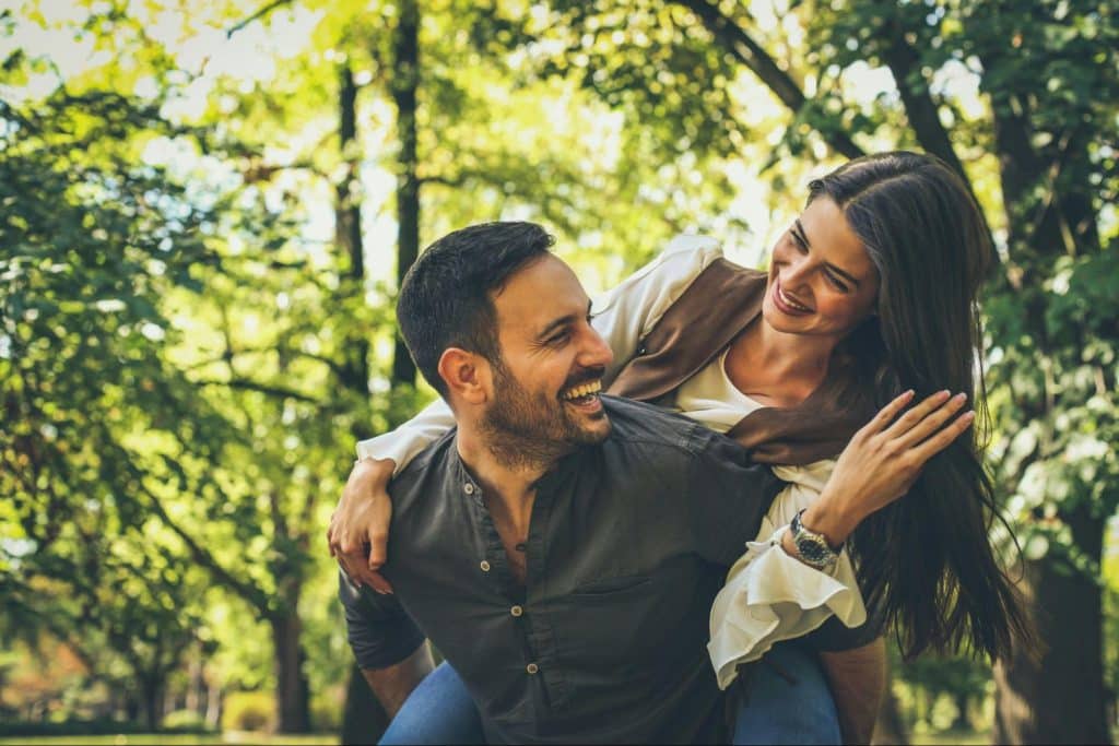 A man making a woman laugh