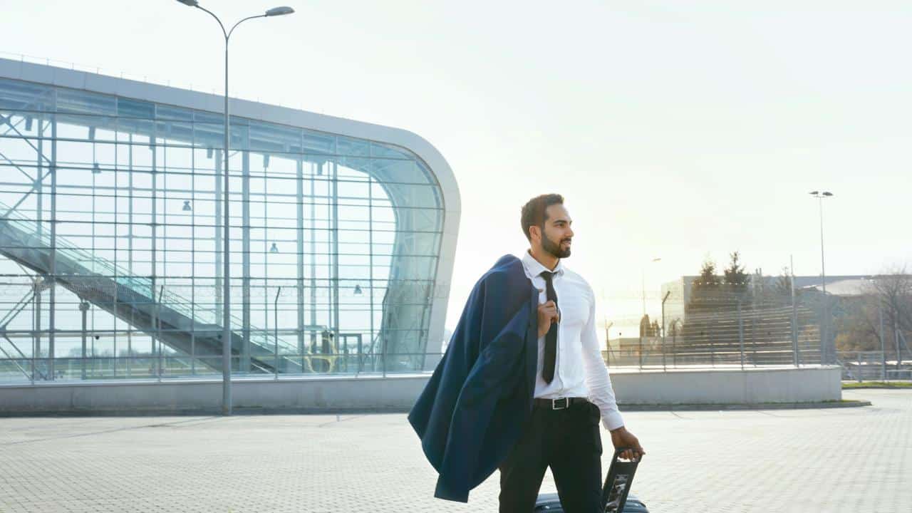 A man in business attire with a suitcase.