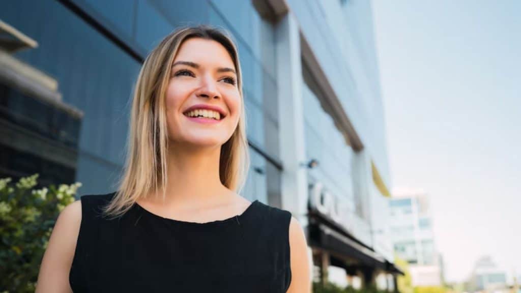 Woman standing strong with a smile, looking forward