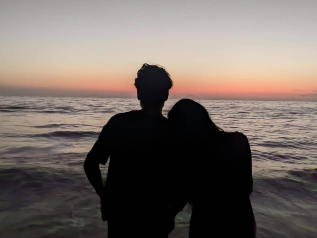 A man and woman watching a sunset 