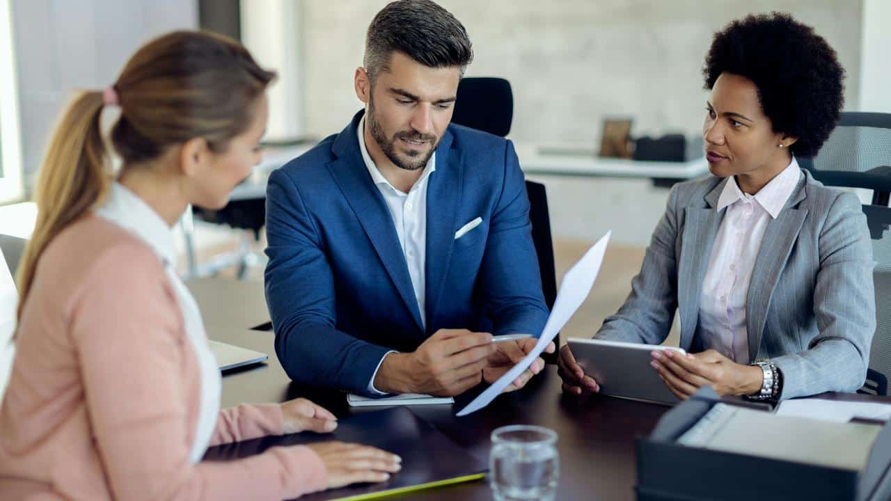A business team reviewing documents at a meeting.