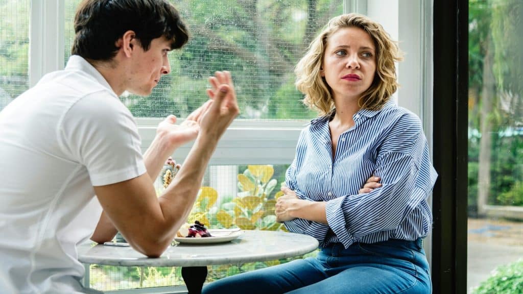 A couple looking sad at a cafe