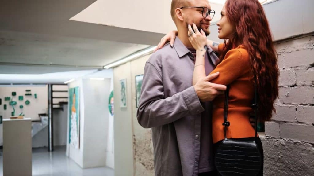Woman leaning in for a kiss while man appears unresponsive