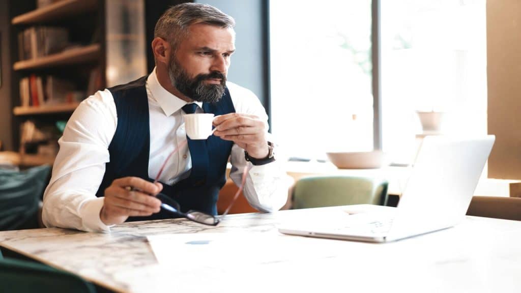 A handsome mature man looking at his laptop.