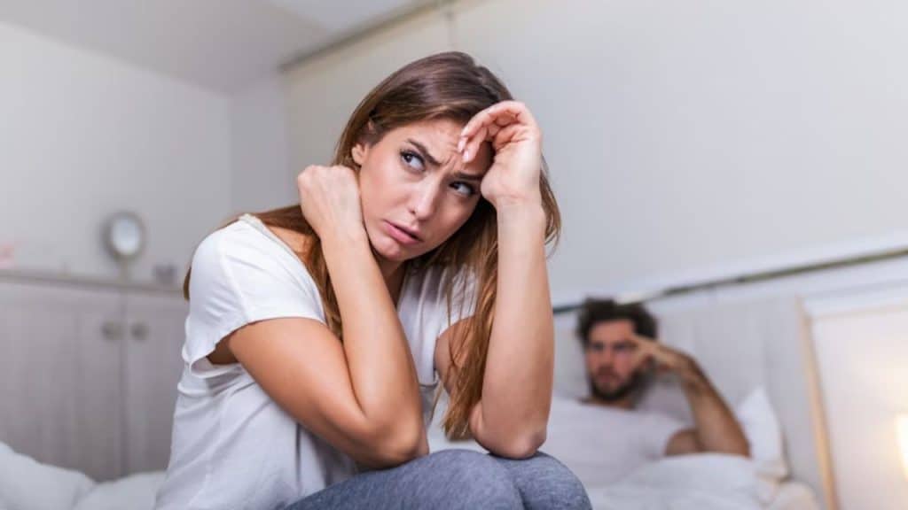 Husband talking while wife avoids eye contact about future plan