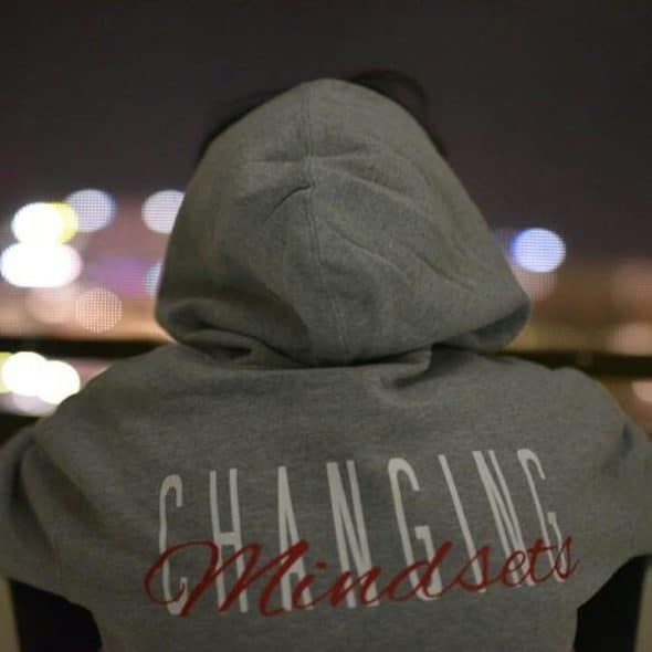 A person wearing a “changing mindsets” hoodie.