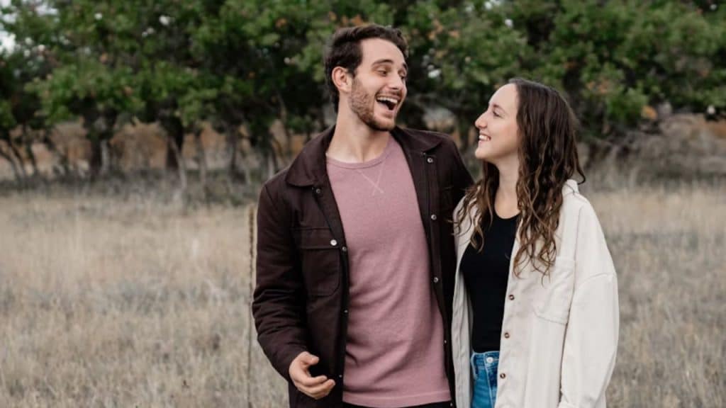 Man laughing at a joke while woman looks hurt and quiet
