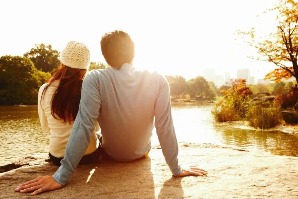 A man and woman watching the sun to set