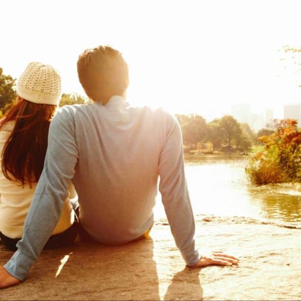 A man and woman watching the sun to set