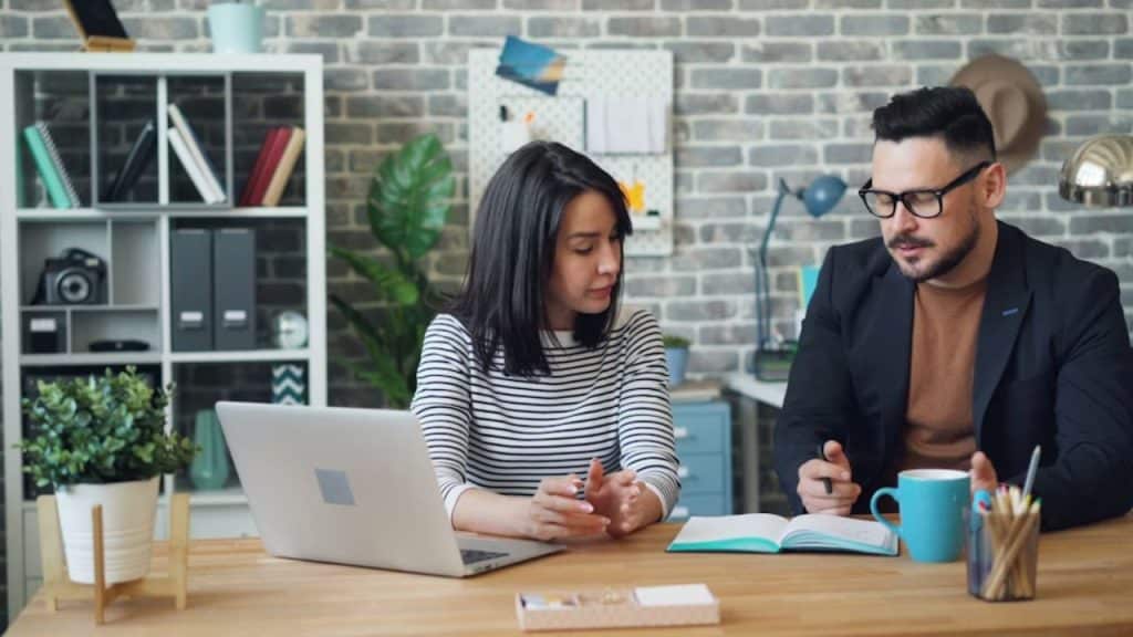 Woman smiling while man interrupts