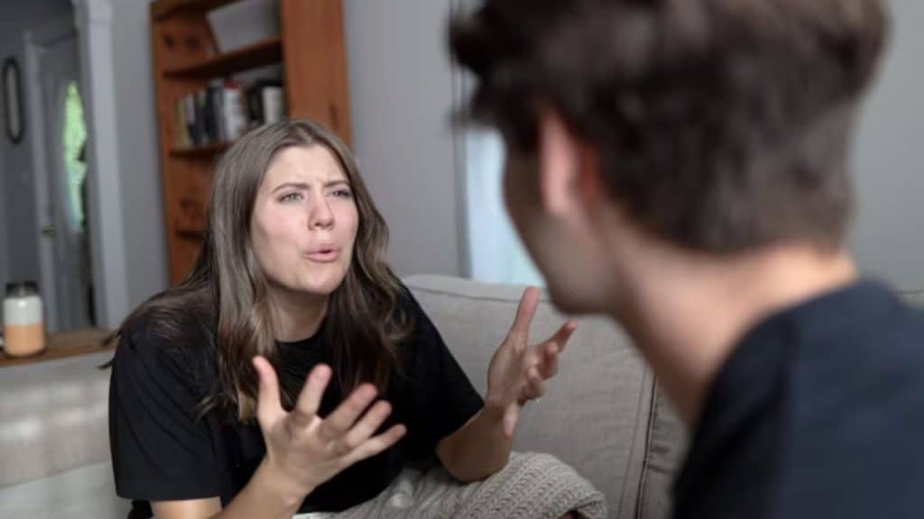 Woman looking irritated as her husband tries to explain something
