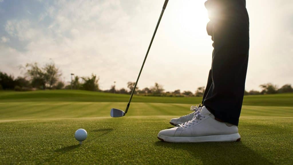 A golfer preparing to hit the ball.