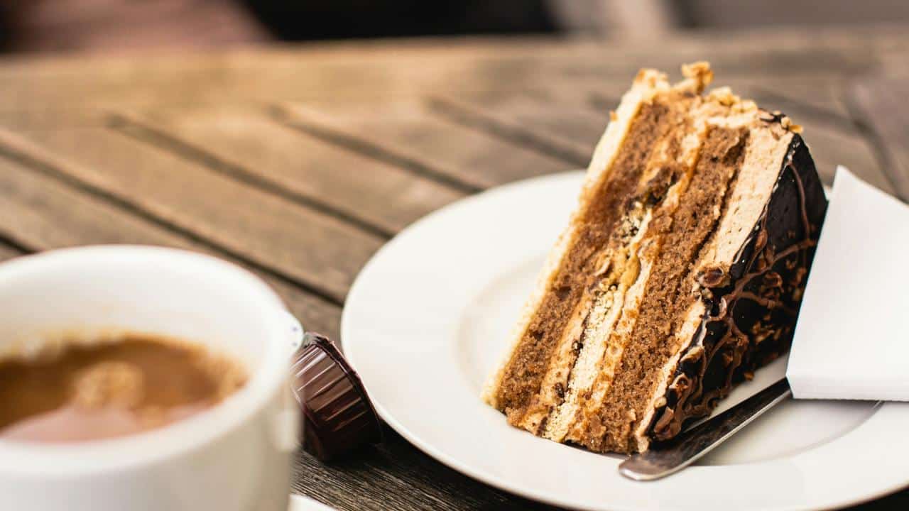 A slice of layered chocolate cake on a plate.
