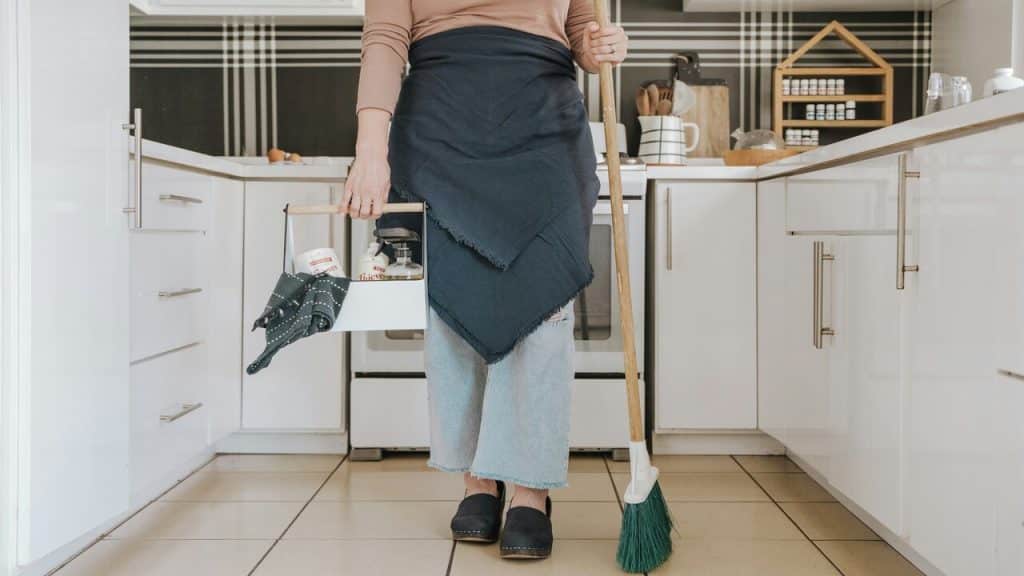 A woman cleaning the kitchen.