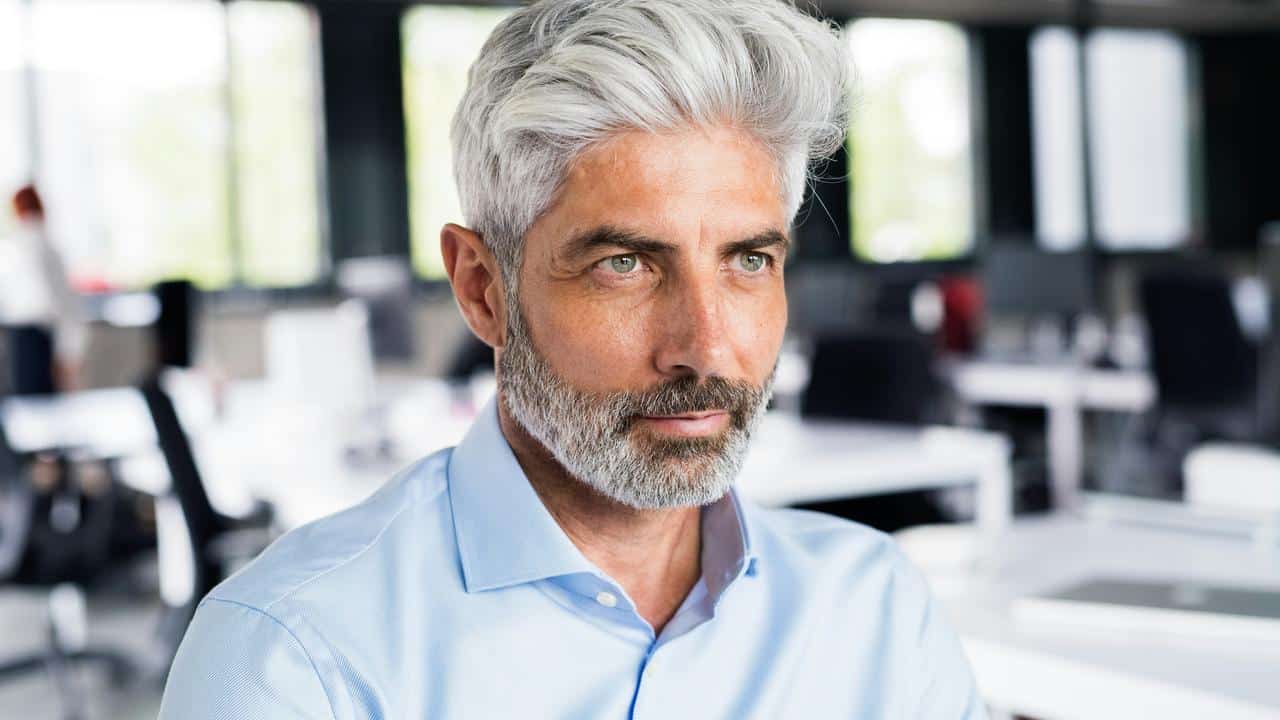 A middle-aged man with a beard in an office.