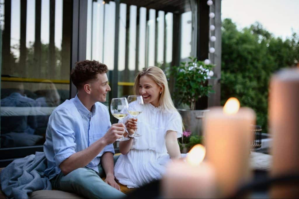 A man and woman toasting glasses