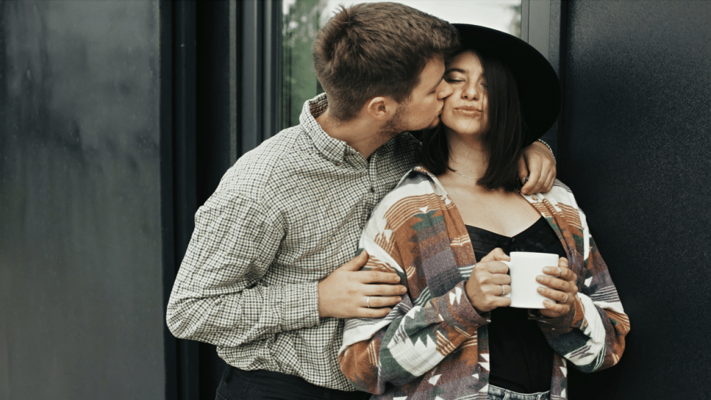 A man kissing his girl.