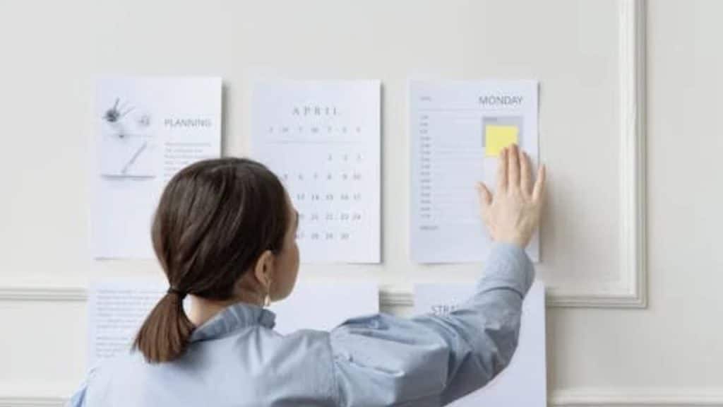 Wife looking at the calendar full of promises with crossed out plans