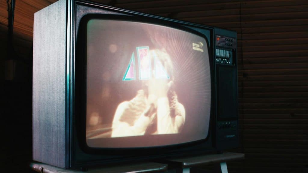 A vintage television showing a blurry performance scene.