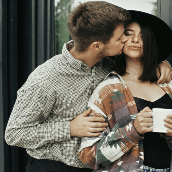 A man kissing his girl.