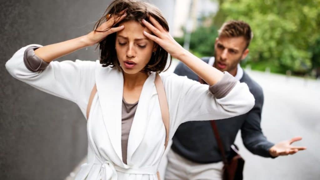 Woman looking upset while man shrugs off her concerns