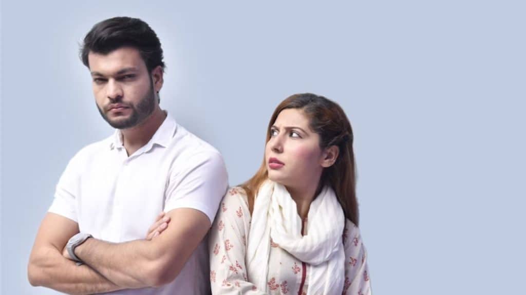 Woman looking disappointed while partner stares blankly