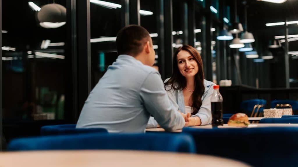 Man reaching for wife’s hand during a quiet conversation