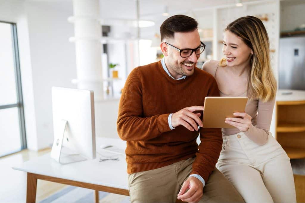 A man and woman having fun looking at the phone 