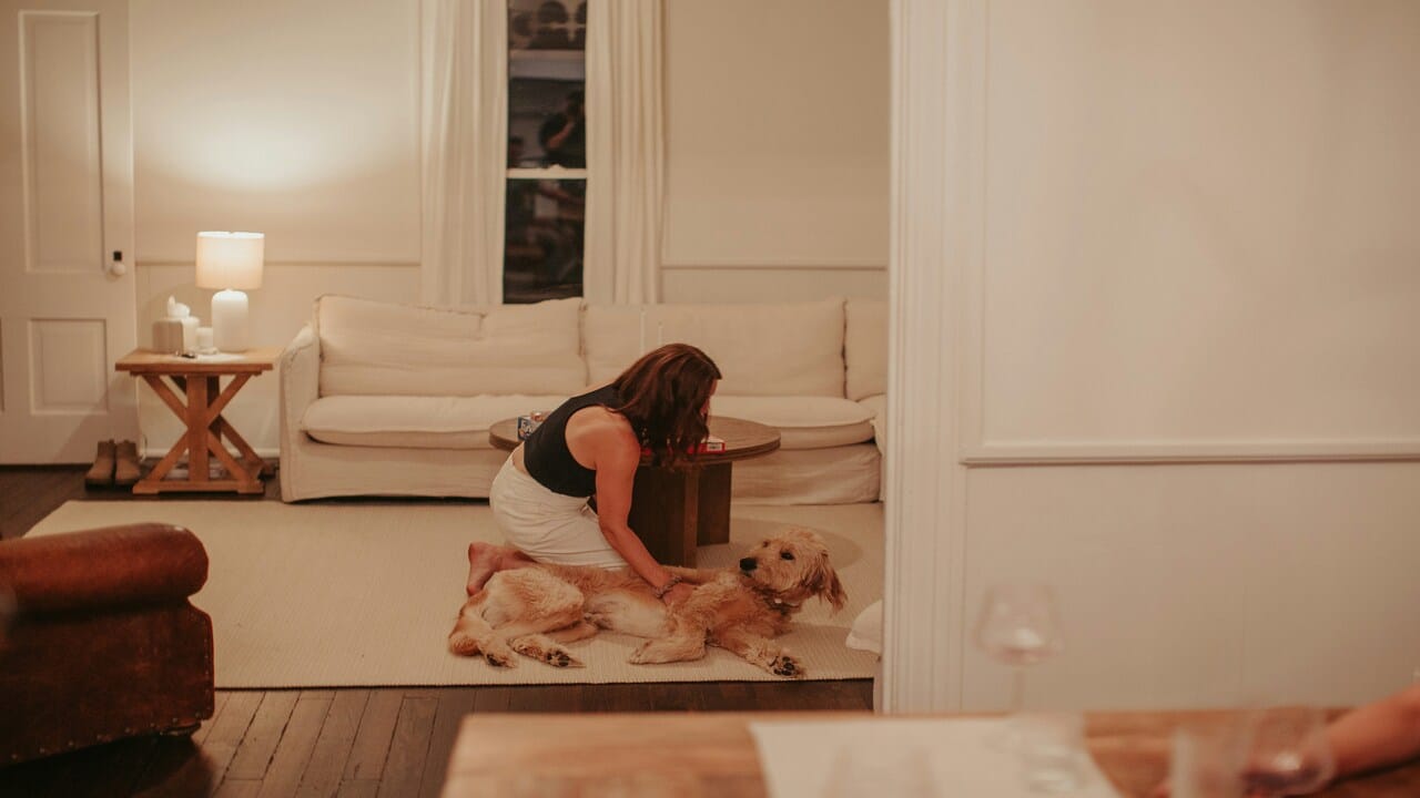 A woman playing with her dog.